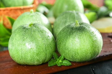 Fresh Green Melons from Shandong China on Wooden Board with Mint Garnish - Healthy Organic Produce