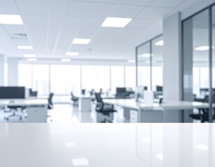 Blurred, bright, modern office space with white desk focus