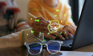 Environmental and sustainability concept, Woman working with computer analyzing data with environmental impact, renewable energy, air pollution reduction targets and carbon emissions with graph
