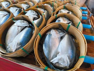Pack of Short-bodied mackerel with bamboo steamer basket in Thai fresh market.