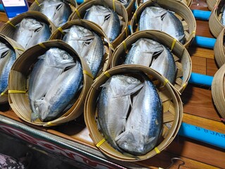 Pack of Short-bodied mackerel with bamboo steamer basket in Thai fresh market.