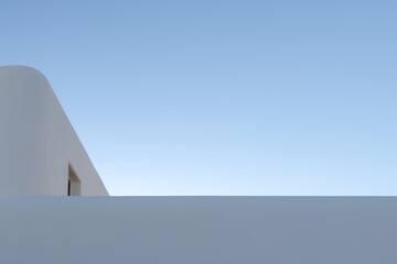 minimalistic elegant whitewashed building on clear blue sky backdrop. abstract architectural background with empty space. building exterior design. modern minimalistic