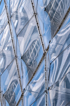 Architectural pattern and reflection on a modern facade captured in minimal geometry and texture, emphasizing structure and design elements of contemporary exterior surfaces