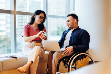 Business partners discuss on laptop and phone
