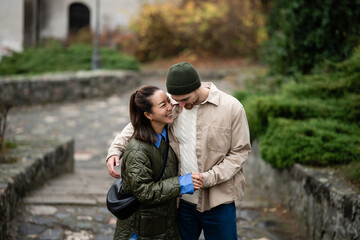Happy diverse couple enjoying autumn romantic walk