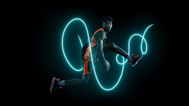 Basketball athlete jumping mid-air surrounded by futuristic glowing lines. Concept of creative sports branding, online fitness content, and energetic digital visuals. - Powered by Adobe
