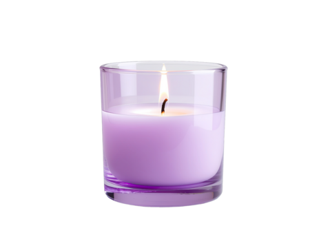 A lit lavender scented candle in a clear glass jar with a black background and a small flame casting a warm glow