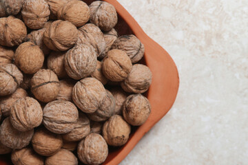 Rustic image of dry walnuts in a bowl	