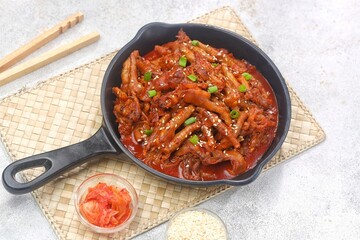 Dakbal (닭발) is a Korean dish made from chicken feet, often spicy, sweet, and chewy, which is popular as a snack or street food.