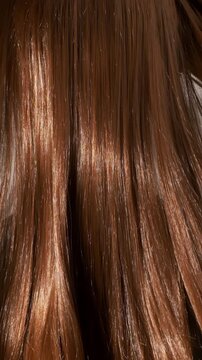 Red female hair moves in slow motion. Texture of ginger female hair close-up.