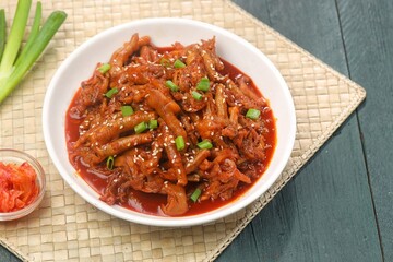 Dakbal (닭발) is a Korean dish made from chicken feet, often spicy, sweet, and chewy, which is popular as a snack or street food.