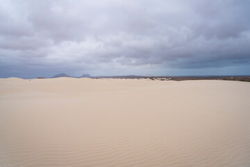 Panorama of sand dunes in Viana desert at overcast day, background mountains, Boa vista , Cape  Verde.