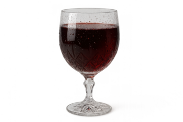 Red wine in a patterned crystal glass. Refreshing drink for parties, holidays, and social gatherings. Transparent background
