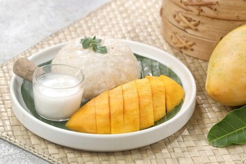 Mango sticky rice is a Thai dessert made from sticky rice, mango and coconut milk.