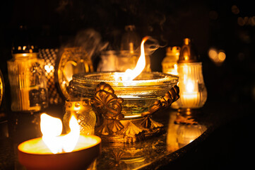 Night scene of a cemetery illuminated by hundreds of candles during All Saints Day. Warm glowing lights, bokeh and flowers creating a peaceful, spiritual atmosphere. Shot in Biały Kościół, Poland.