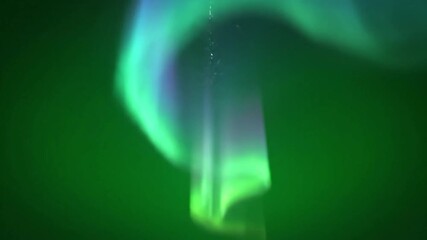 Mystical green aurora borealis dancing across a dark night sky - Powered by Adobe