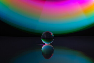 Abstract colorful irregular lines with glass bubble on black background and wall texture. Long exposure. Light painting photography.