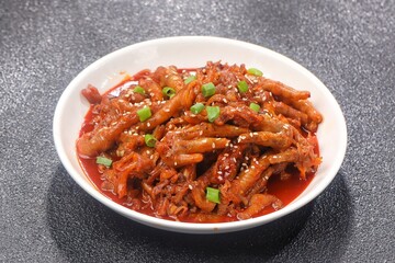 Dakbal (닭발) is a Korean dish made from chicken feet, often spicy, sweet, and chewy, which is popular as a snack or street food.