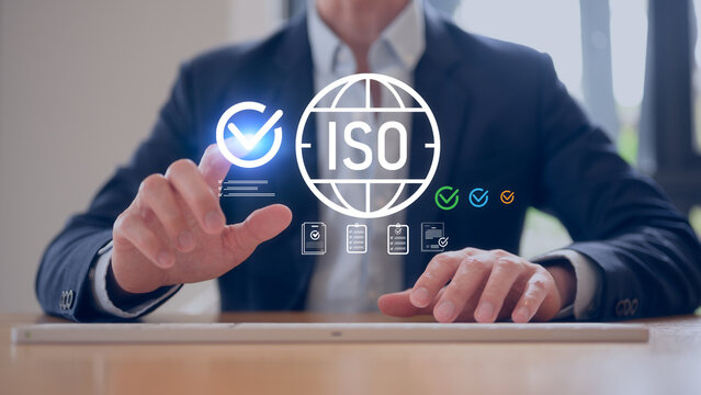 Businessman typing on keyboard working with Iso quality management system iso certification iso standards iso audit iso compliance and standards process - Powered by Adobe