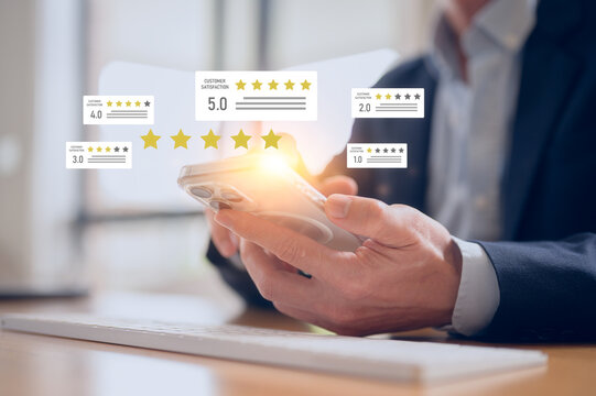 Customers give 5-star reviews,symbolizing excellent customer feedback, and user satisfaction in digital service. Businessman using smartphone to give five star positive review with smiley face icon