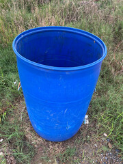 blue water plastic bucket in garden