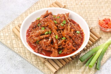 Dakbal (닭발) is a Korean dish made from chicken feet, often spicy, sweet, and chewy, which is popular as a snack or street food.