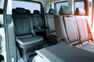 The interior of a modern vehicle showcases spacious seating with high-quality black material,...