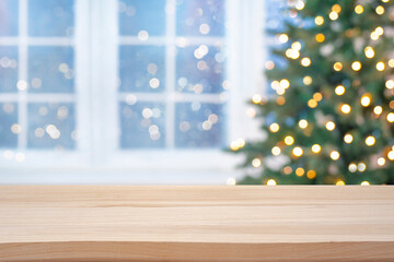 Wooden table top for product display on blurred Christmas fir tree lights and festive window interior background