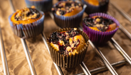 Blackberry muffins on rustic background. Selective focus.