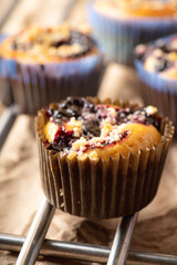 Blackberry muffins on rustic background. Selective focus.