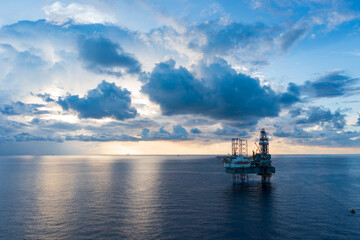 Offshore jack up rig in aerial view in the middle of the ocean taken by a drone