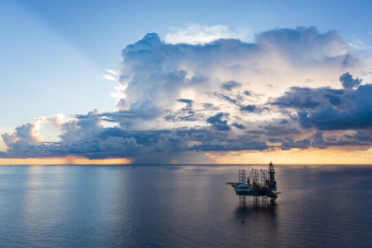 Offshore jack up rig in aerial view in the middle of the ocean taken by a drone