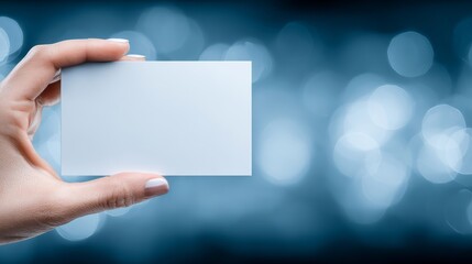 Obraz premium Professional hand holding blank white business card presentation for branding and networking identity.