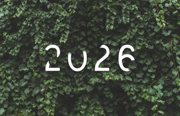 2026 New year white text hidden in natural green leaves wall