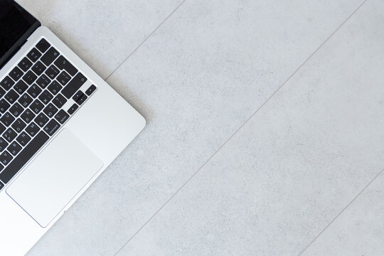 Minimal close up of laptop part on neutral gray background with copy space. Modern technology concept for business, digital work, and communication design.