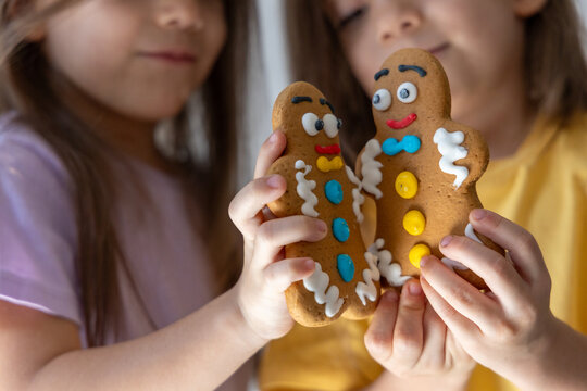 Christmas Gingerbread man cookies in kids hands.