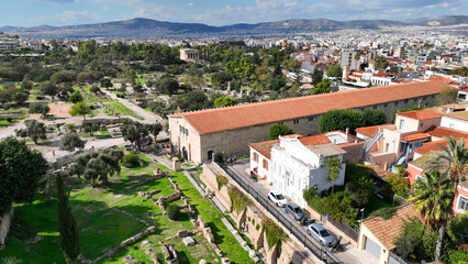 Aerial drone photo of iconic Ancient Agora of Athens built below Acropolis hill featuring Temple of...