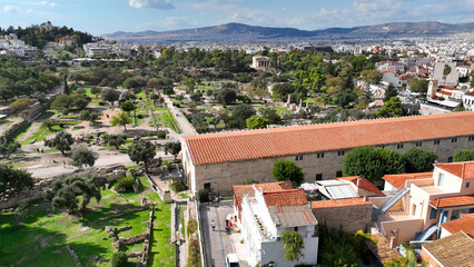 Aerial drone photo of iconic Ancient Agora of Athens built below Acropolis hill featuring Temple of...