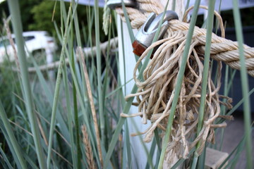 Rope fence with metal clamp and wooden post