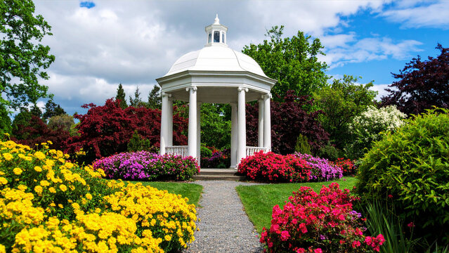 Historic architecture of an old European garden pavilion building with a dome, sky, and flowers in a summer park landscape - Powered by Adobe