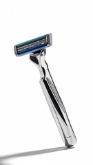 Sleek metal razor with blue blades on a white background