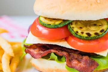 Delicious homemade burger with crispy bacon and fresh toppings