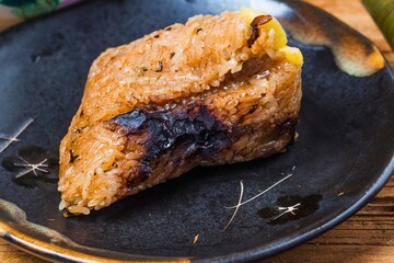 Savory roasted meat with herbs on a dark plate