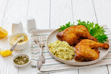 roast chicken legs with coleslaw on a plate