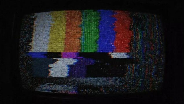 Static Screen of a Retro Television: A retro television displays a colorful test pattern on a static-filled screen, a nostalgic symbol of a bygone era.