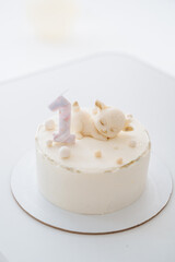 Cute birthday cake with number 1 candle, first birthday celebration