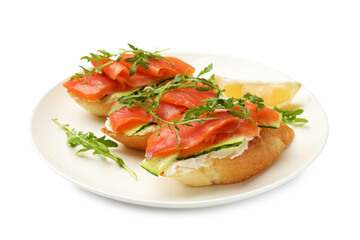 Tasty bruschettas with salmon, cream cheese, cucumber, arugula and lemon isolated on white