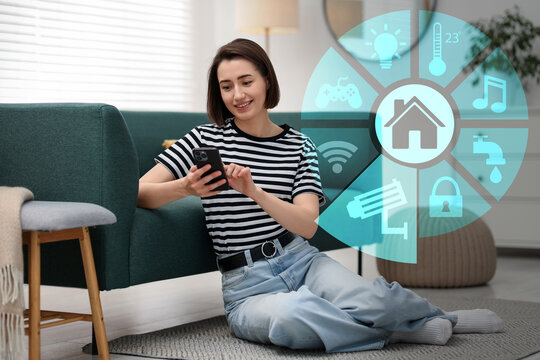 Smart home. Different icons on virtual screen and happy woman using mobile phone in room