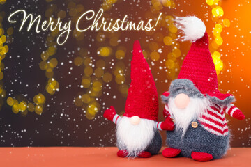 Merry Christmas greeting card. Cute gnomes on color background with blurred festive lights, bokeh...