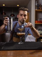 Bartender carefully pouring an ingredient